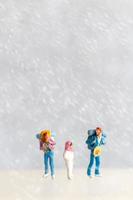 Miniature people Happy family Travel in winter time photo