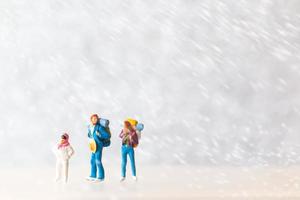 Miniature people Happy family Travel in winter time photo