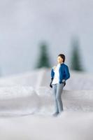 Miniature people woman Travel in winter time photo