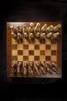 Chess pieces of wood on a beautiful chessboard. A puzzle game with tricky combinations that requires planning and thinking. photo