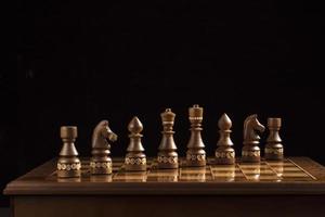 Chess dark pieces on a chess field. A puzzle game with tricky combinations that requires planning and thinking. photo