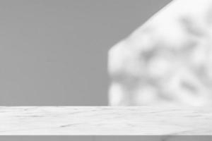 Marble table with window shadow drop on white wall background for mockup product display photo