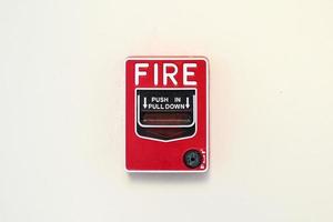 Fire alarm switch on white wall background photo