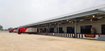 Ratchaburi, Thailand-February 27, 2023 Cargo or Warehouse for storage and transport parcel for shipping by mail and copy space. Building for distribution, Import and Export goods by red container car photo