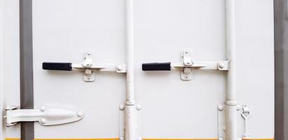 White steel door of cargo container with black handle closed for keeping asset and protect inside cabinet. Security, Safe and Protection concept photo