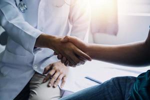 Doctor and patient discussing something while sitting at the table . Medicine and health care concept. Doctor and patient photo