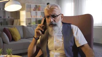 Self-employed Mature Man With Beard Gets Bad News On The Phone. Bearded Freelance Man Answering Phone Helpless Expression of Anger and nervousness. video