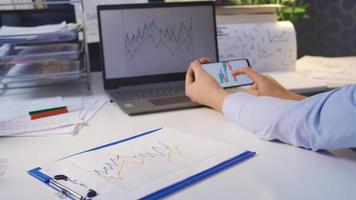 Trader looking at digital and drawn stock market charts. Man Analyzing Market Data Information. video