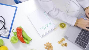 Dietitian preparing diet plan. Nutritionist working on computers in his office. Diet and healthy living plans. video