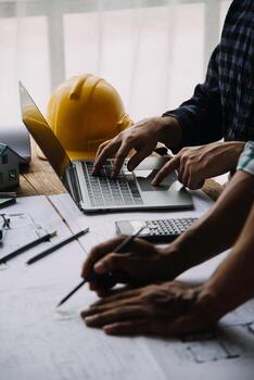 Construction and structure concept of engineer working drawing on blueprint meeting for project working with partner on model building and engineering tools in working site, construction concept photo