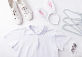 white polo shirt and bunny ears for mockup design photo