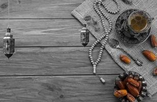 A cup of dates and a cup of tea on a table.a background for Ramadan. Social media posts .Muslim Holy Month Ramadan Kareem .Ramadan Mubarak beautiful greeting card photo