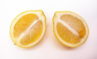 A slice of yellow lemon isolated in white background photo