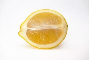 A slice of yellow lemon isolated in white background photo