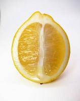 A slice of yellow lemon isolated in white background photo