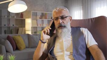 Bad News By Phone. Mature man talking on the phone gets bad news. video