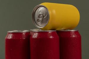 Cold red soda cans with a yellow one for conceptual use photo