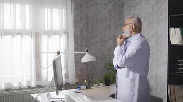 Senior doctor man thoughtful about patients. Senior mature man is thinking and pensive. video