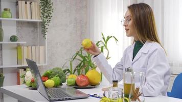 The dietitian talks about healthy life and diet in the video call. The dietitian doctor is video chatting with his patient and tells him the diet list consisting of vegetables and fruits.