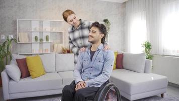 Disabled man and his girlfriend are happy at home. Sincere Friendship. Woman and disabled man having happy time at home. video