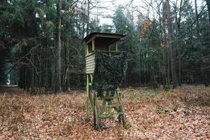 Tree stand or deer stand, open or enclosed platform used by hunters photo