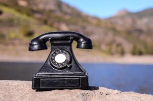 Vintage telephone on a rock
