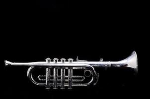 SIlver trumpet on black background photo