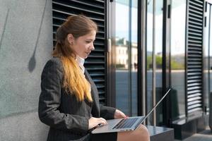 Way to success. Business woman works. Female college student sits near photo