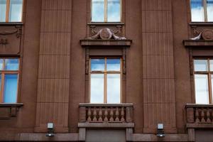 facade of a building with windows, the sky is reflected in the windows photo