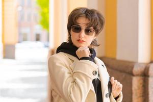 Hipster young girl with backpack enjoying in Central city, traveler photo