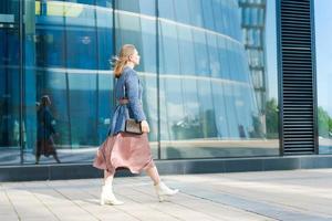 Successful happy woman on her way to work in street. Confident business woman photo