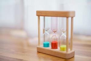 Colorful hourglasses with blurred background cute concept photo