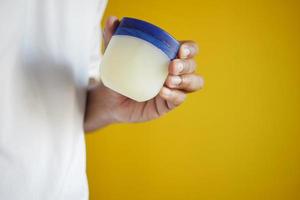 Close up of man hand using petroleum jelly photo