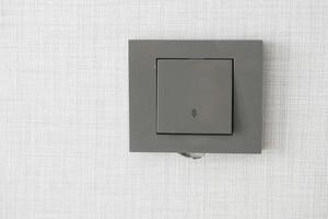 a lighting switch against white wall photo