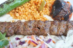 Seekh Kabab, Naan bread, and sauce on a plate photo