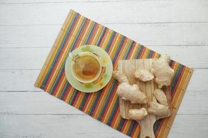 Ginger tea on wooden background. photo