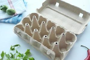 egg carton without eggs on table , photo