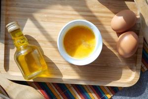 top view of egg and oil jar on table photo