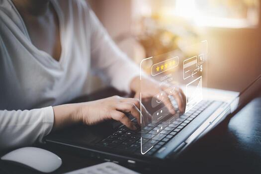 Woman using laptop with Customer review satisfaction feedback survey concept, User give rating to service experience on online application, service leading to reputation ranking of business. photo