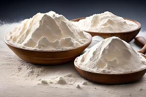 Three bowl of flour on the table that is full of flour spill, studio shot and marketing presentation. photo