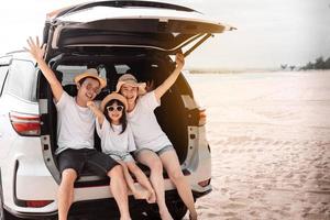 Family with Car travel driving road trip summer vacation in car in the sunset, Dad, mom and daughter happy traveling enjoy holidays and relaxation together get the atmosphere and go to destination photo