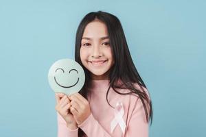 woman holding happy smile face on paper cut, user giving good feedback rating, think positive , customer review, assessment, of mental health day, Compliment Day, satisfaction concept. photo