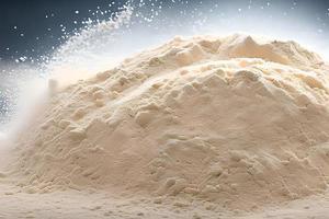 Heap of flour isolated on gray background, studio shot and marketing presentation. photo