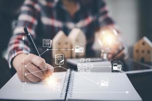 Hand using pen write project and  folder of document Management System,  online documentation database and process automation to efficiently manage files work, knowledge, Corporate business technology photo