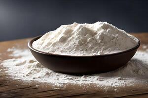 A bowl of flour on the table, studio shot and marketing presentation. photo