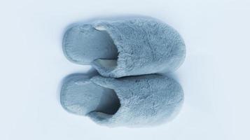 Woman blue wool fluffy warm-lined slippers isolated on white. photo