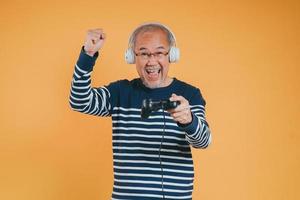 Asian Senior older man family having fun enjoying play video game funny video. Happiness lifestyle on retirement concepts. photo