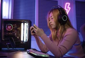 Asian woman gamer play computer video game concept. photo