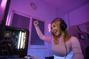 Asian woman gamer play computer video game concept. photo