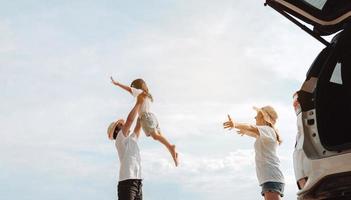 Happy Family with car travel road trip. summer vacation in car in the sunset, Dad, mom and daughter happy traveling enjoy together driving in holidays, people lifestyle ride by automobile. photo